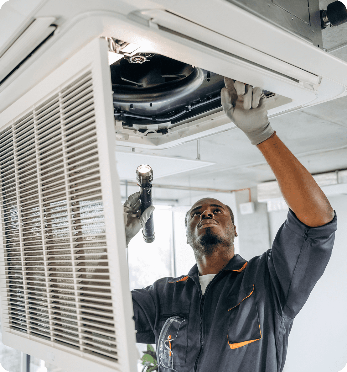Maintenance worker fixing air conditioning system